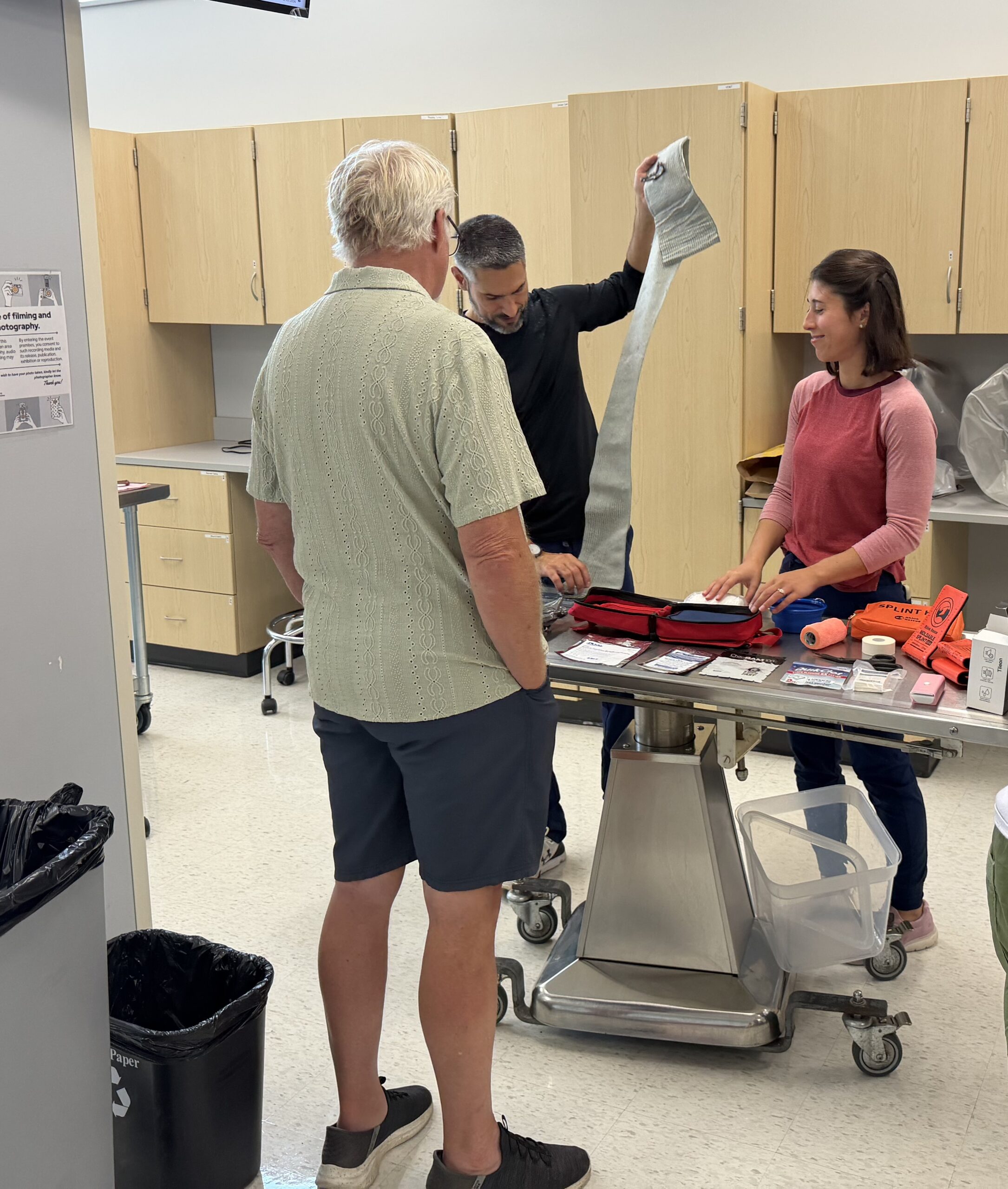 Dr. Bilko and Dr. Almeida demonstrate pet ER products for field medicine purposes to a client; First Aid Basics Class; 2026