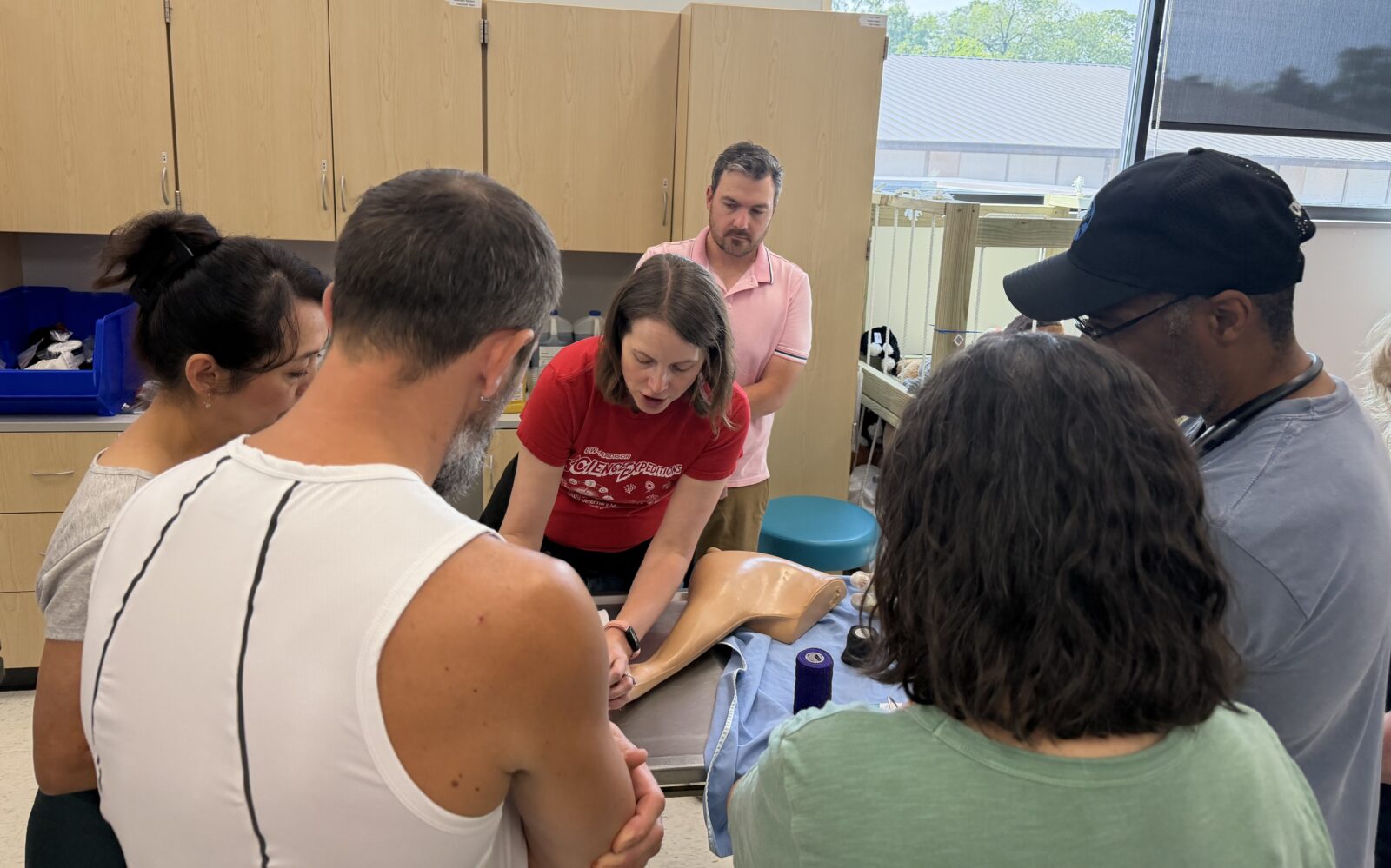 Dr. Nichelason demonstrates proper wound bandaging with clients; First Aid Basics class; August 2026