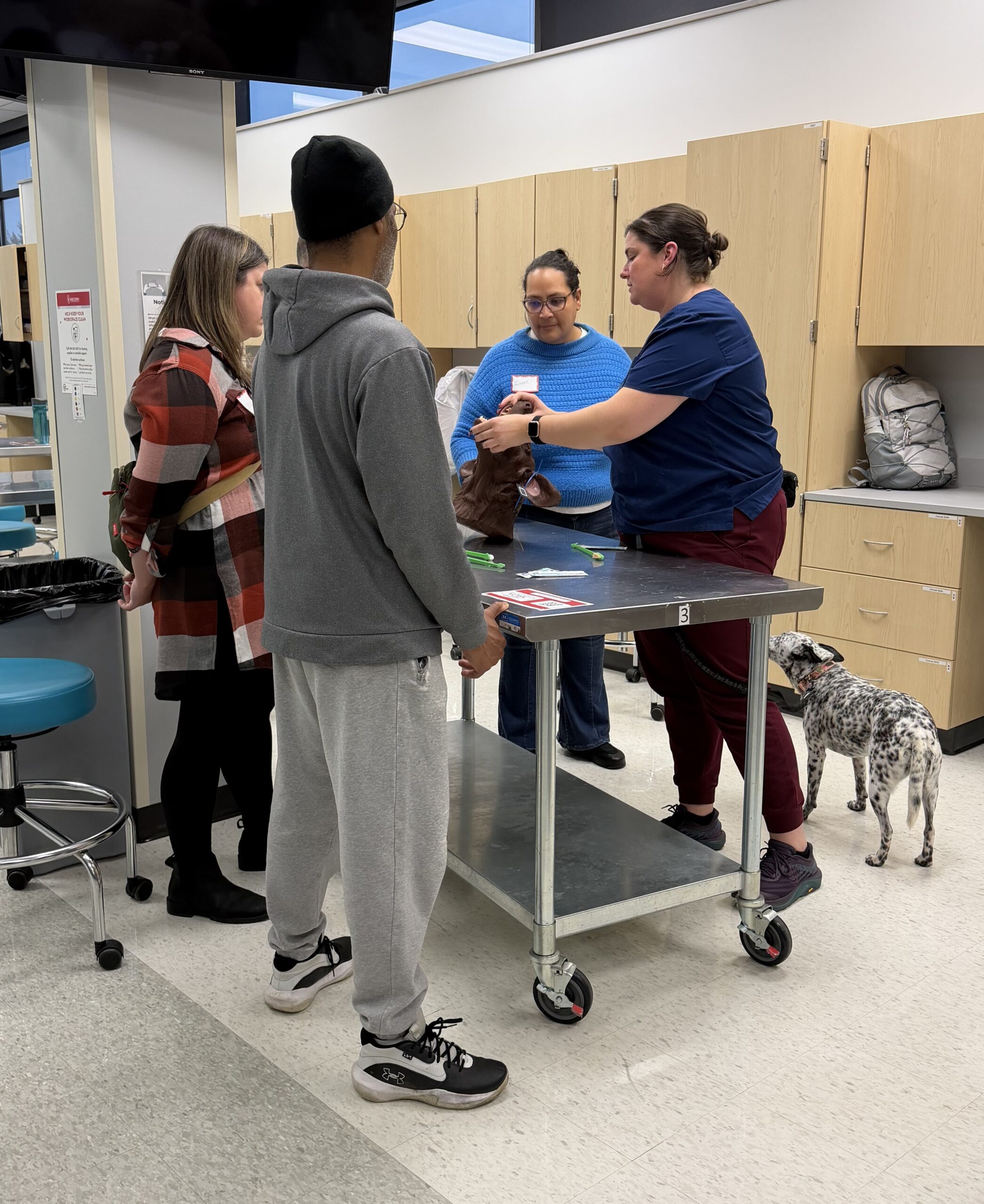 CVT Morgan Kelly teaches clients about canine toothbrushing using a patient model. Care Made Easy; September 2026